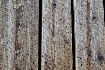 Weathered wood board worn by time. Background wooden board. Brownish wood plank