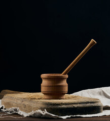 Empty brown plates and wooden spoon on a wooden table