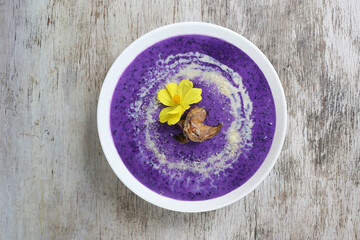 Famous Ube Champorado served in dish isolated on wooden background top view of breakfast