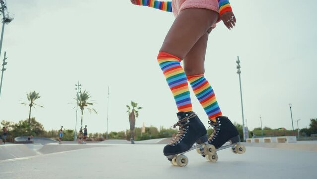 Beautiful woman skating with roller skates and having fun. Professional skater and dancer training in the morning