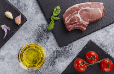 raw pork steak with tomatoes and herbs