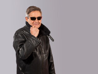 elderly man with black leather jacket and sunglasses