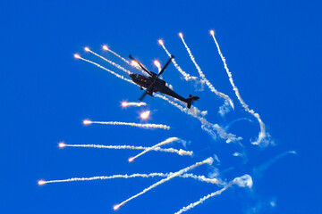 Attack helicopter firing defensive flares