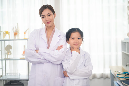 Education science school concept, Happy Asian woman teacher and student girl in science school ,Asian woman teacher and student design for Education science school