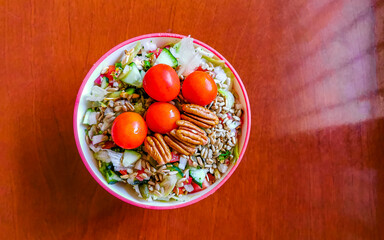 Bowl of salad with cucumber tomato greens broccoli Mexico.