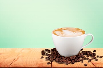 A cup with tasty aroma coffee on wooden table