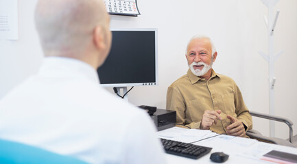 Elderly man sitting consulting male doctor