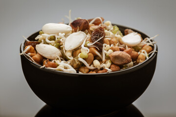 Close-up of A mix of organic sprout seeds sprouting ( germinating) bowl contains almond, groundnut,...