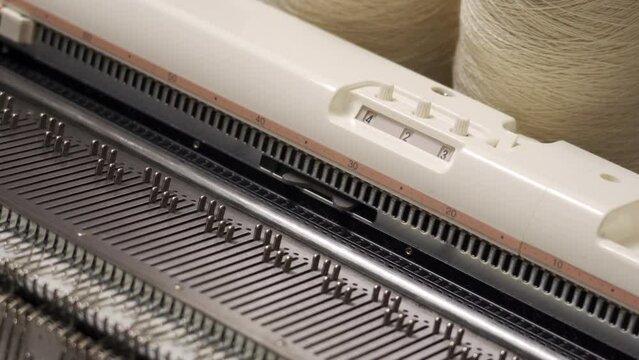 Knitting machine close-up. Knitted clothes handmade