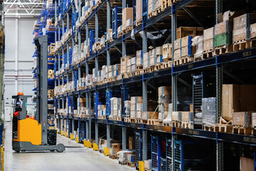 Modern warehouse interior with shelves and boxes and forklift loader © Mulderphoto