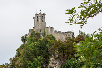 Fototapeta na wymiar View of the Chesta Tower on Monte Titano in San Marino capital. Tower on a cliff over 800 meters high in an independent country San-Marino in the heart of Italy, Europe. High quality photo