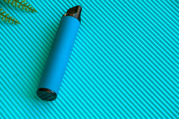 blue disposable electronic cigarette isolated on blue background. The concept of modern smoking, vaping and nicotine. blue elf bar. Vape with blueberry flavor. High quality photo