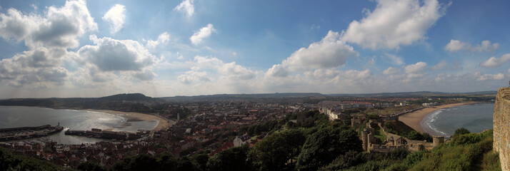 wide panoramic view of the town of scarborough showing the harbour, lighthouse, town buildings,...