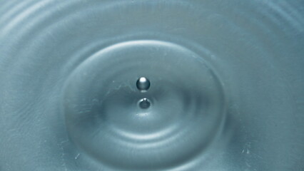 Aqua blob splashed transparent liquid closeup. Falling drop inside water surface
