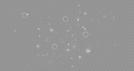 Dust sparks and stars shine with a special light. Christmas light effect. Glittering particles of magic dust.Vector sparkles on a transparent background.