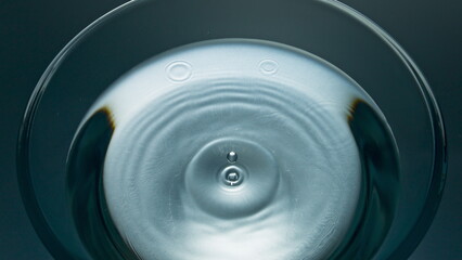 Macro aqua drop flowing refreshing drink. Falling blob liquid diverging circles