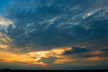 Bright dramatic sky with clouds at sunset