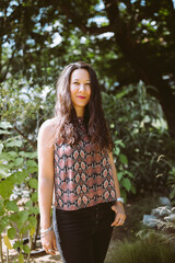 Happy young mixed-race Japanese woman in summer park
