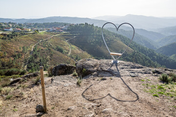 Heart shaped seat and shadow with a view to the mountains