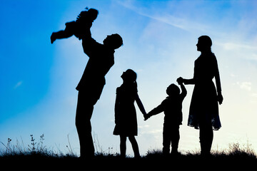 happy family by the sea on nature silhouette background