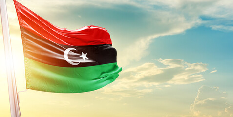Libya national flag cloth fabric waving on the sky - Image