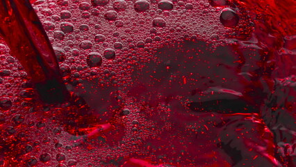 Bubbled red wine pouring glass slow motion. Alcoholic liquor filling wineglass