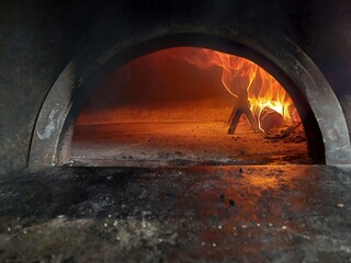 Pizza oven with burning woods