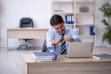 Young male employee working in the office