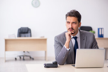 Young male employee working in the office