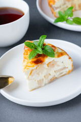 Baked Sweet Cottage Cheese casserole with apple decorated mint. Copy space