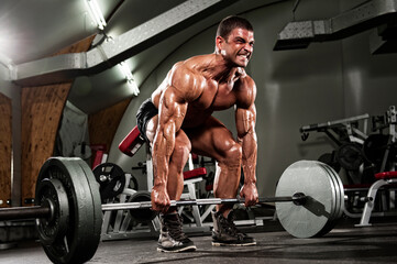 Fototapeta na wymiar Muscular Men Lifting heavy weights, performing dead lift exercise