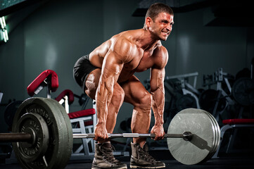 Muscular Men Lifting heavy weights, performing dead lift exercise - obrazy, fototapety, plakaty