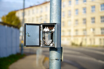 Metal distribution box on a pole with wires and tags for inscription