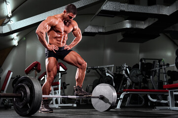 Fototapeta na wymiar Muscular Man at the |Gym preparing to lift heavy weights