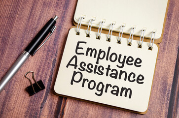 word EAP Employee Assistance Program text on white paper on wooden background
