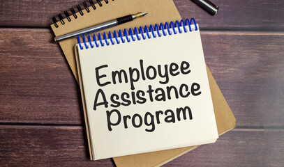word EAP Employee Assistance Program text on white paper on wooden background