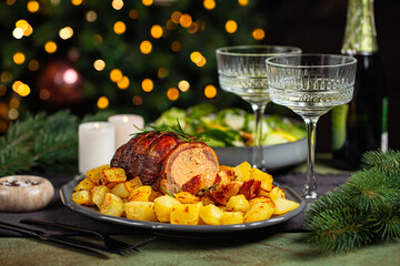 Christmas or New Year dinner table. Close-up of baked duck roulade stuffed with meat and oranges,...