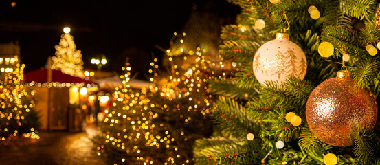 European Christmas city with festive fair or market in the evening. Christmas tree with beautiful...
