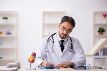 Young male doctor cardiologist working in the clinic