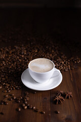 Cup of coffee and milk beans at wood table. Homemade coffee at table