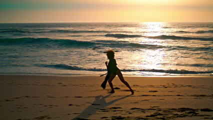 Silhouette woman dancing beach sunrise. Girl moving body seductively on wet sand