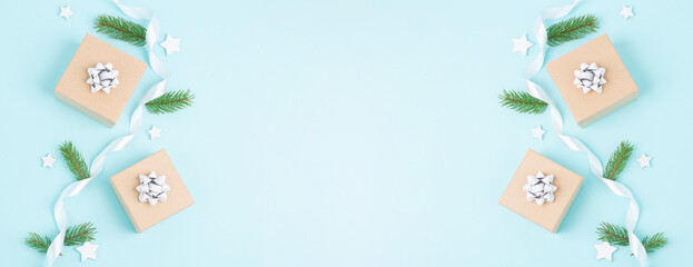 Christmas holiday greeting card with little gift boxes, stars and fir branches, blue background
