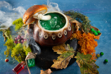 Witch kitchen. Witcher magic cauldron with green boiling poison and smoke for Halloween. Fly agaric...