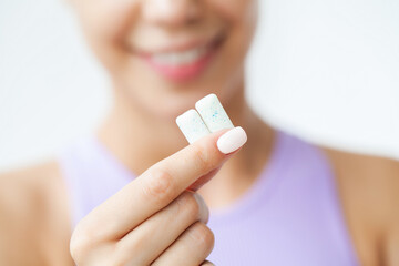 Smile young woman eating white chewing gum