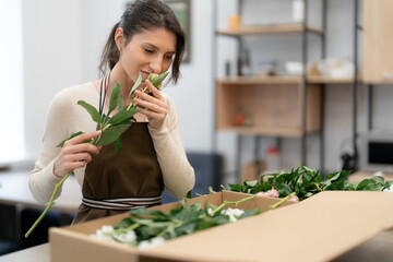 Florist working with flowers making a composition