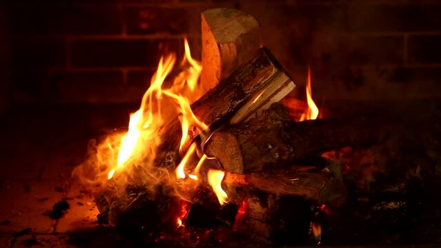 Burning wood in the fireplace, flames of fire