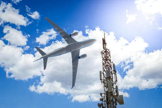 Mobile phone cell tower with 5G on the C Band frequencies with aircraft on the background