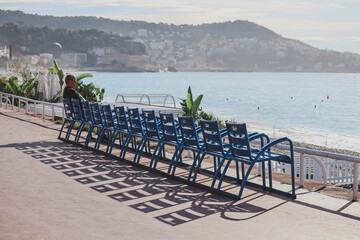 Nice, France - 29.09.2022 :  Famous blue chairs on the Promenade des Anglais in Nice