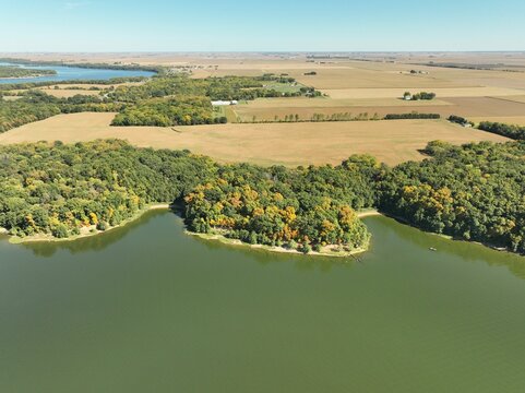 Aerial View Of A Green Lake And Forested Landscape