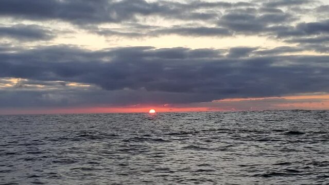 Mexico - March, 2022 - Sun rising from the ocean swells off the coast of Mexico.